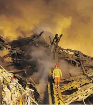  ?? EBRAHIM NOROOZI / THE ASSOCIATED PRESS ?? An Iranian firefighte­r works at the scene of the collapsed 17-storey Plasco building after it was engulfed by a fire in Tehran. The collapse occurred while fire crews were working to tame the blaze and evacuate the building.