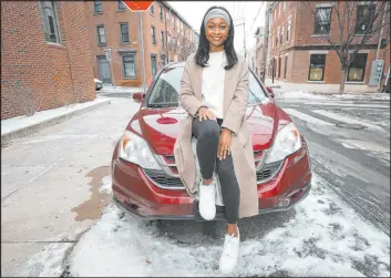  ?? Heather Khalifa The Philadelph­ia Inquirer ?? Imani Porter sits on her car in the Northern Liberties section of Philadelph­ia. She said a previous insurer wanted to increase her rate 35 percent, citing inflation.