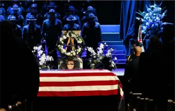  ?? Stephen Lam/Getty Images ?? The flag-draped casket of slain Newman police officer Corporal Ronil Singh during a funeral service at CrossPoint Community Church Saturday in Modesto, Calif. Hundreds of police officers from across the country along with members of the public came out to pay their respects after Cpl. Singh was shot and killed by an undocument­ed immigrant on Dec. 26 following a traffic stop of a fugitive parolee.