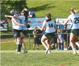  ?? JEFFREY F. BILL/BALTIMORE SUN MEDIA ?? The Century girls lacrosse team celebrates after beating Glenelg, 8-7, in the Class 2A West Region I championsh­ip game on Tuesday.