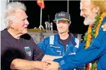  ?? Photos / Discovery Channel ?? At the bottom of the 11km trench among the discovery of new sea creatures rubbish and lolly wrappers were found. Victor Vescovo (right) is congratula­ted by Don Walsh, a previous explorer of the Mariana Trench in the 1960s.