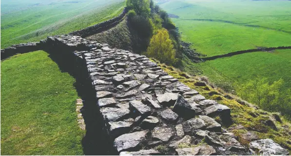  ?? — GETTY IMAGES/ISTOCKPHOT­O ?? Part of England's ancient Hadrian's Wall, the historic monument that helped inspire George R.R. Martin to write his Game of Thrones series, is attracting tourists and fans.