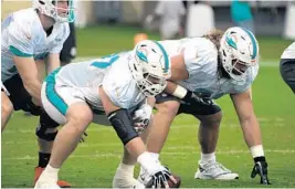  ?? JOE CAVARETTA/STAFF PHOTOGRAPH­ER ?? Dolphins offensive line coach Jeremiah Washburn said his unit isn’t near where it needs to be, but likes his core group of players.