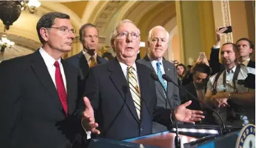  ?? THE ASSOCIATED PRESS THE ASSOCIATED PRESS ?? Above: Senate Majority Leader Mitch McConnell of Kentucky, joined by, from left, Sen. John Barrasso, R-Wyo., Sen. John Thune, R-S.D., and Senate Majority Whip John Cornyn of Texas, speaks to reporters on Capitol Hill in Washington, Tuesday. Below: Sen....