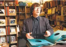  ?? Lea Suzuki / The Chronicle 1999 ?? Musician Roy Loney is seen working behind the counter at the Jack’s Record Cellar store in the Lower Haight.