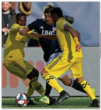  ?? STuART CAHILL / HeRALd sTAFF FILe ?? THROUGH THE ACADEMY: Hamilton native Justin Rennicks of the Revs, who came up through the Revolution Academy, tries to step through a pair of Columbus defenders last year.