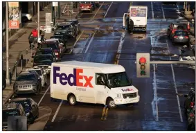  ?? (AP/David Zalubowski) ?? A FedEx delivery vehicle makes a U-turn near the Denver Pavilions in late December , in downtown
Denver.