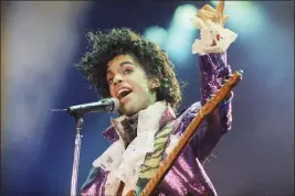  ?? LIU HEUNG SHING — THE ASSOCIATED PRESS FILE ?? Prince performs at the Forum in Inglewood on
Feb. 18, 1985.