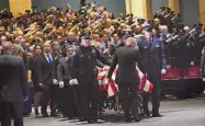  ?? JIM THOMPSON/JOURNAL ?? Officers salute as the flag-draped casket of APD officer Daniel Webster is brought into Kiva Auditorium in November 2015.