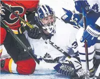  ?? DEREK LEUNG GETTY IMAGES ?? Jack Campbell took a beating in the Leafs’ net against the crease-crashing Flames on Sunday, but earned the win.