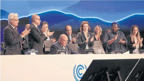  ?? REUTERS ?? Delegates applaud as COP27 President Sameh Shoukry delivers a statement during the closing plenary session at the COP27 climate summit in Sharm el-Sheikh on Sunday.