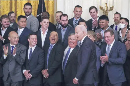  ?? JULIO CORTEZ — THE ASSOCIATED PRESS ?? Los Angeles Dodgers manager Dave Roberts, third from bottom left, reacts as President Joe Biden arrives at an event to honor the 2020World Series champion Dodgers baseball team at the White House on Friday in Washington.