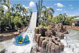  ?? PHOTOS BY PATRICK CONNOLLY/STAFF ?? The new Infinity Falls ride, shown here Friday, is in the test phase at SeaWorld in Orlando. Below, kayaks serve as props near the queue for the new ride. No opening date has been announced yet.