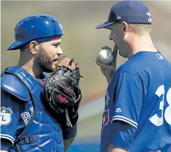  ?? NATHAN DENETTE/CP FILES ?? Toronto Blue Jays catcher Russell Martin, left, visits the mound to talk with relief pitcher Joe Smith during a spring training game last month in Dunedin, Fla.