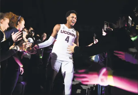  ?? Jessica Hill / Associated Press ?? Jalen Adams is greeted by fans as he is introduced during UConn’s annual First Night celebratio­n in Storrs on Oct. 12.