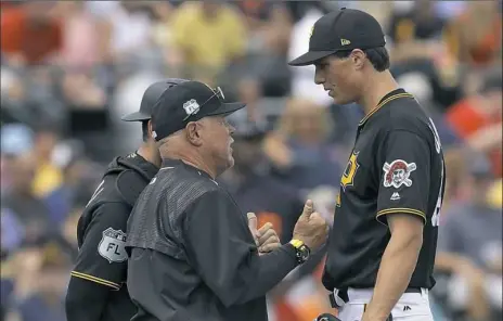  ?? Chris O’Meara/Associated Press ?? Pitching coach Ray Searage, left, makes a visit to the mound to confer with pitcher Tyler Glasnow Saturday at LECOM Park in Bradenton, Fla.