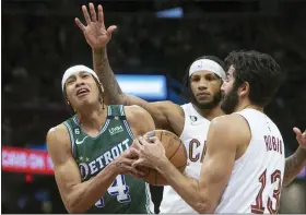  ?? PHIL LONG — THE ASSOCIATED PRESS ?? Detroit Pistons’ R.J. Hampton (14) competes for the ball against Cleveland Cavaliers’ Ricky Rubio (13) as Lamar Stevens watches during the second half in Cleveland, Saturday.