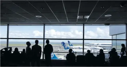  ??  ?? Passengers wait for their flights at Auckland Airport.