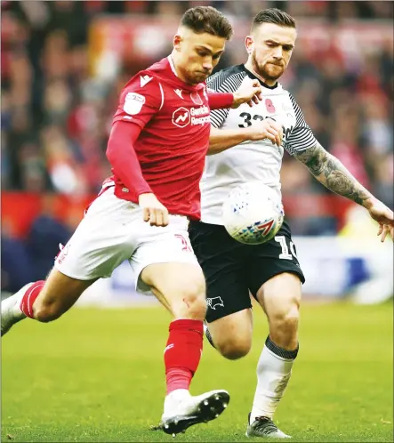 ??  ?? TUSSLE: Nottingham Forest’s Matty Cash, left, and Derby County’s Jack Marriott