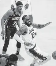  ?? Marcio Jose Sanchez / Associated Press ?? LeBron James left Saturday’s loss to Atlanta with a high right ankle sprain and is out indefinite­ly.