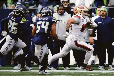  ?? John Froschauer / Associated Press ?? Niners tight end George Kittle eludes Seattle’s Bobby Wagner and Ryan Neal on his way to the end zone in the second quarter.