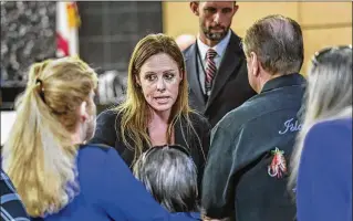  ?? PHOTOS BY LANNIS WATERS / THE PALM BEACH POST ?? Assistant State Attorney Lauren Godden talks with family members of James Barry after Circuit Judge Glenn Kelley declared a mistrial Friday.