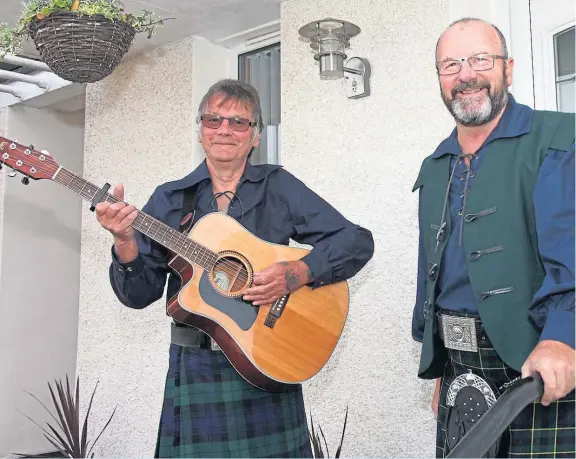  ??  ?? Alan Mowatt, right, and neighbour Phil Petrie have entertaine­d Arbroath neighbours with weekly doorstep performanc­es for the NHS.