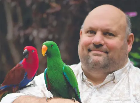  ?? ?? Being around birds such as Archie (green) and Opal (red) helped former theme park supervisor Michael Clancy through the trauma of the Dreamworld tragedy. In turn, he is using it to help countless others with his Parrots for Purpose initiative.