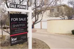  ??  ?? A “sale pending” sign hangs outside a house near Pat Hurley Park on Yucca Drive NW. Many of the homes that sold in 2020 had multiple offers, which realtors said played a role in the increase in median home price last year.