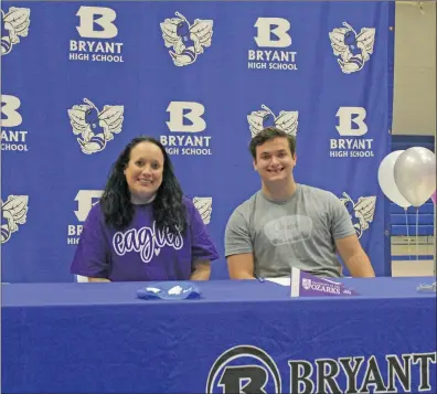  ?? TONY LENAHAN/THE Saline Courier ?? Bryant senior Tyler Peters, right, is all smiles after signing with the University of the Ozarks Eagles with his mother Carmen YoungPhill­ips by his side at Bryant High School.