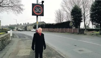  ??  ?? Stanhill resident, Malcolm Broughton, on Stanhill Road where locals say people often drive at speeds up to 50 miles an hour