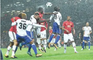  ??  ?? Manchester United's Belgian striker Romelu Lukaku, center, heads the ball to score his team's second goal during the UEFA Champions League Group A football match between Manchester United and Basel at Old Trafford in Manchester, north west England on...