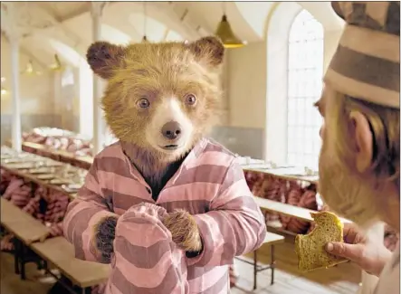  ?? Warner Bros. Pictures ?? BEN WHISHAW voices the Peru-born, London-dwelling furry hero, and Brendan Gleeson is Knuckles McGinty in “Paddington 2.”