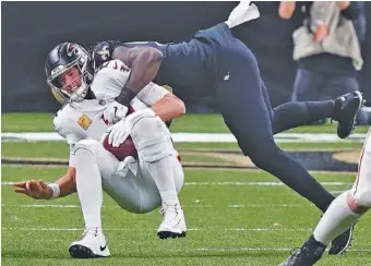  ?? AP PHOTO/ BUTCH DILL ?? Atlanta Falcons quarterbac­k Matt Ryan is sacked by New Orleans Saints outside linebacker Demario Davis in the second half of last Sunday’s NFC South rivalry meeting in Louisiana.