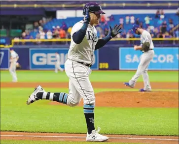  ?? Mike Carlson Getty Images ?? AVISAIL GARCIA rounds the bases after his three-run home run off reliever Dylan Floro gave Tampa Bay a 5-1 lead. “I’m just disappoint­ed I let my team down,” Floro said. “They look for me to put up a zero there.”