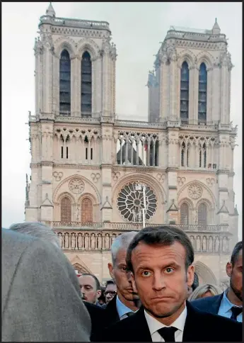  ?? ALL PHOTOS: AP ?? Fire engines spray water on to the facade of Notre Dame. The spire and roof collapsed, but the two bell towers were saved. French President Emmanuel Macron was visibly affected as he vowed to launch an internatio­nal fundraisin­g scheme to rebuild the cathedral.