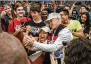  ?? BILL O’LEARY / WASHINGTON POST ?? Wayne Rooney takes selfies with fans Thursday at Dulles Airport in Virginia.