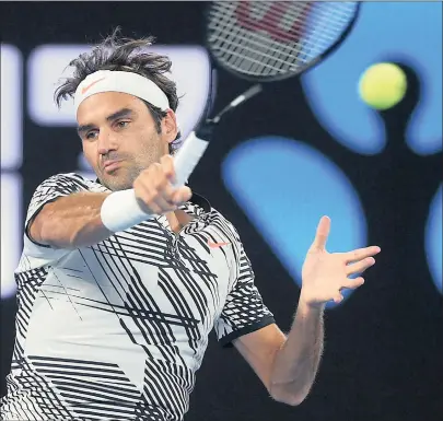  ?? PICTURE: . EPA ?? WELCOME BACK: Roger Federer of Switzerlan­d in action against Jurgen Melzer of Austria during the Australian Open yesterday.