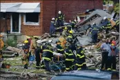  ?? JULIO CORTEZ — THE ASSOCIATED PRESS ?? Fire department personnel carry a person out of the debris after an explosion in Baltimore on Monday.