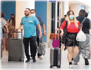  ?? MARCIO JOSE SANCHEZ/ASSOCIATED PRESS ?? Travelers roll their luggage at Los Angeles Internatio­nal Airport on April 25. The market for travel subscripti­ons has started to expand, and now includes cheap flights, airport lounges, luxury accommodat­ions and high-end credit cards.