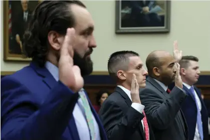  ?? Photograph: Alex Wong/Getty Images ?? Former FBI agent Garret O’Boyle, far left, is sworn in during the subcommitt­ee hearing.