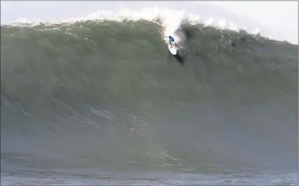  ??  ?? RIDE OF HIS LIFE: Grant ‘T wiggy’ Baker takes off at Mavericks on the wave that earned the 2008 XXL Ride of the Year award.