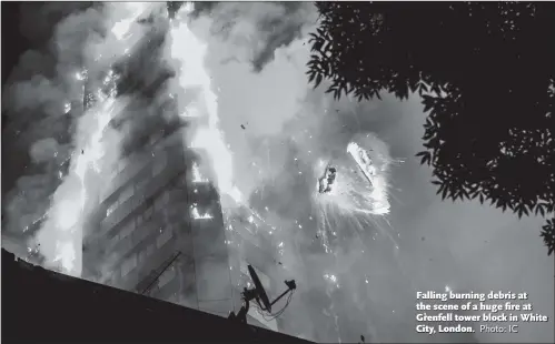  ?? Photo: IC ?? Falling burning debris at the scene of a huge fi re at Grenfell tower block in White City, London.