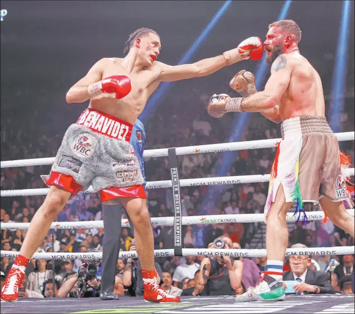  ?? Erik Verduzco Las Vegas Review-journal ?? David Benavidez, left, throws a punch against Caleb Plant during their super middleweig­ht fight Saturday at the MGM Grand Garden. Benavidez won by unanimous decision.