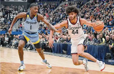  ?? Jessica Hill/Associated Press ?? UConn’s Andre Jackson Jr. (44) dribbles while defended by Marquette’s Kam Jones (1) on Tuesday night.