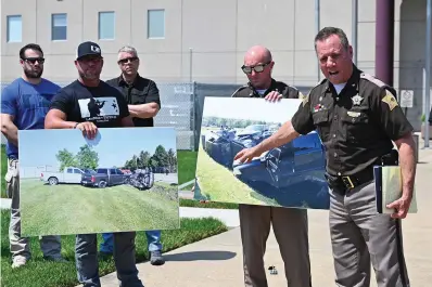  ?? The Associated Press ?? Vandenburg­h County Sheriff Dave Wedding, right, refers to a photograph during a press conference Tuesday in Evansville, Ind., about the capture of fugitives Casey White and Vicky White.