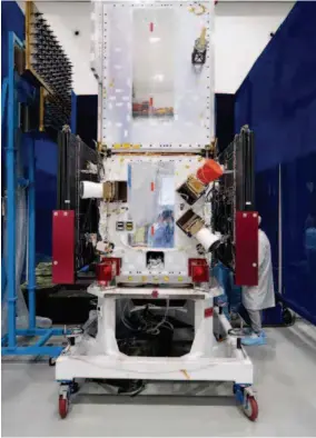  ??  ?? Technician­s prepare for the launch of a Beidou-3 satellite. VCG