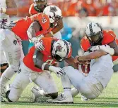  ?? [PHOTO BY SARAH PHIPPS, THE OKLAHOMAN] ?? Oklahoma State linebacker­s Justin Phillips (19) and Calvin Bundage (1) both return as starters this season.