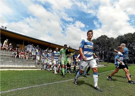  ?? CHRIS SYMES/PHOTOSPORT ?? Callan Elliot leads Tasman United onto the field for their match against Auckland City.