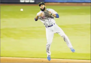  ?? Lynne Sladky / Associated Press ?? New York Mets shortstop Amed Rosario throws to first where Miami Marlins’ Jon Berti was out in the seventh inning on Saturday in Miami.